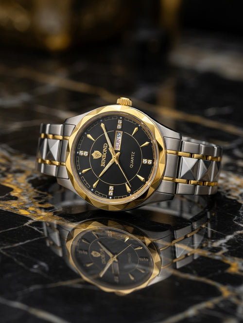 Luxury watch with gold and silver band on a reflective surface