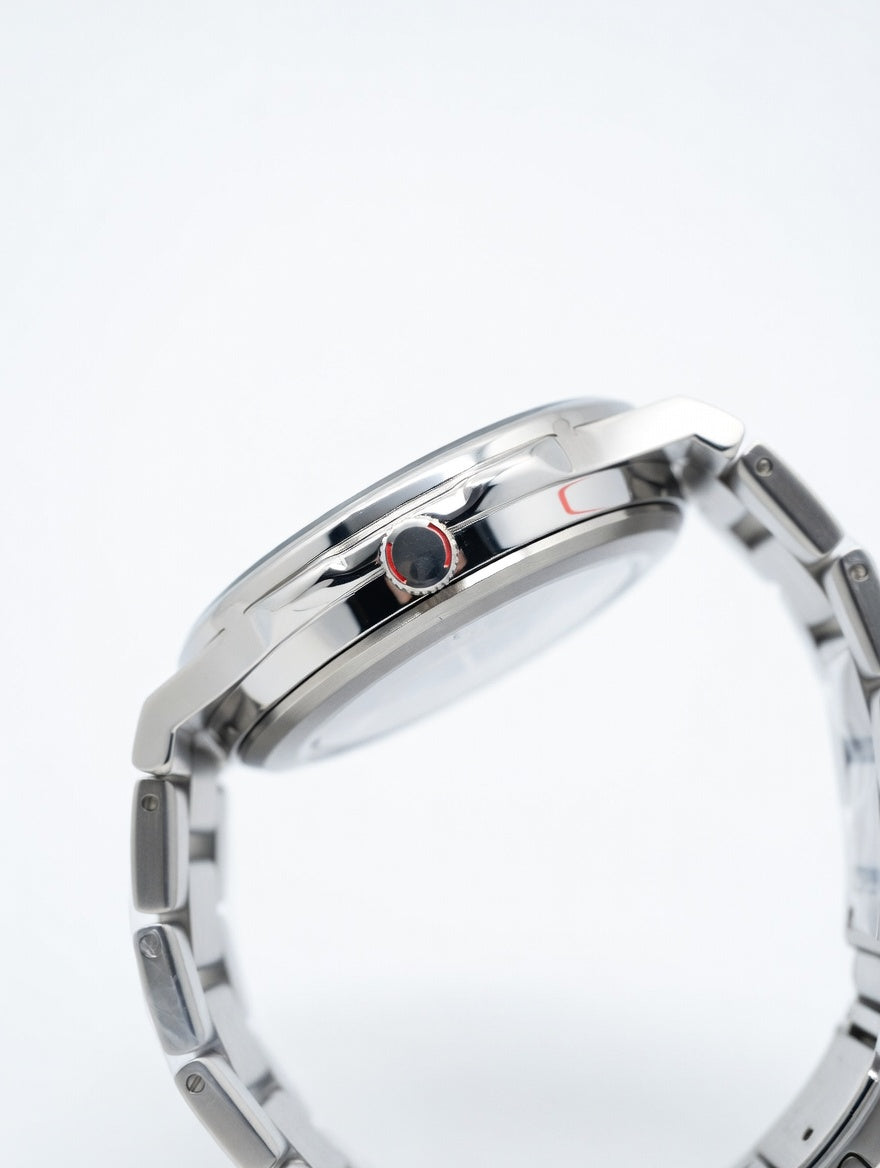 Close-up of a silver bracelet with a red accent on a white background