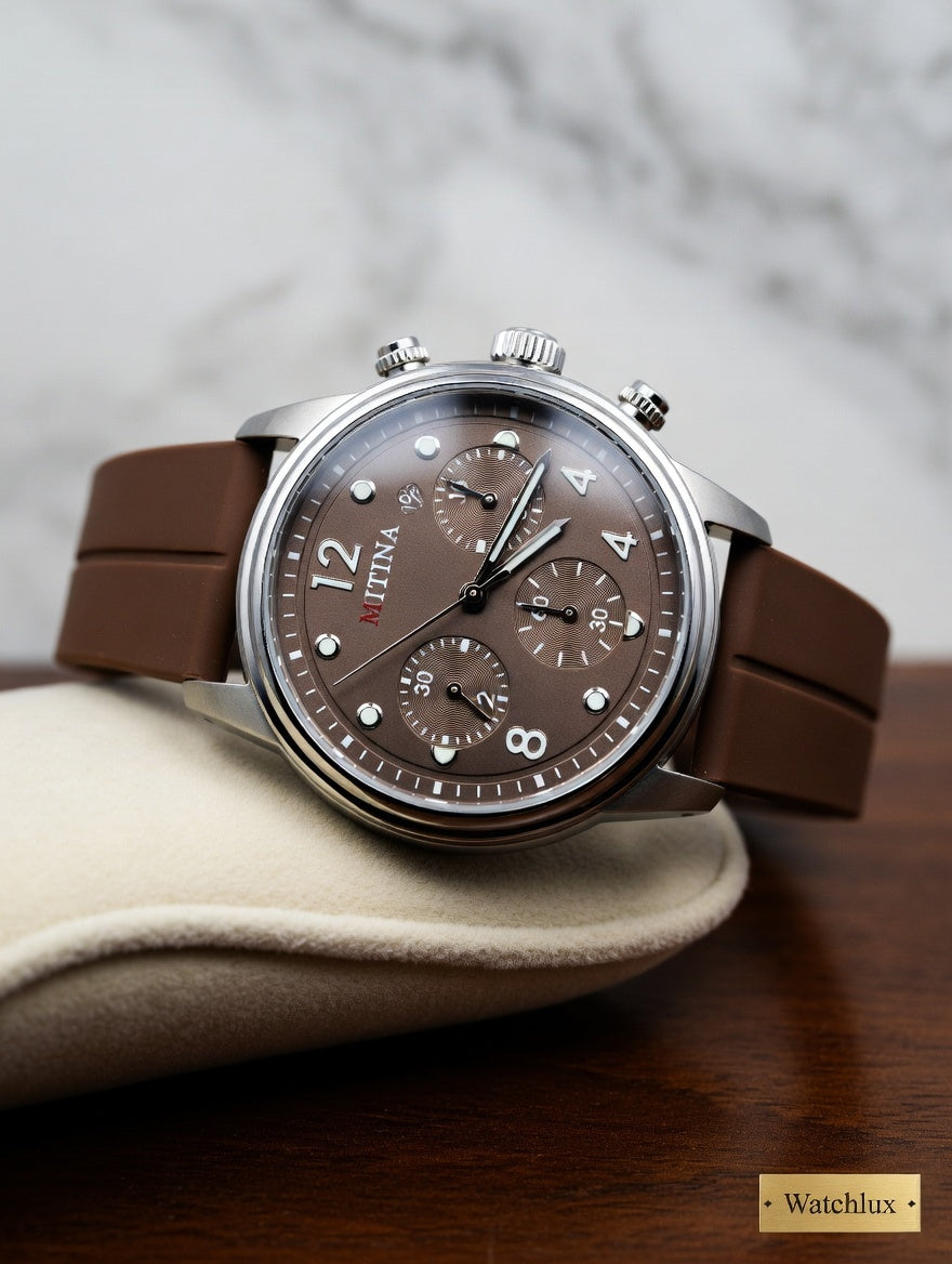 Luxury mens brown leather watch with chocolate brown dial and chronograph subdials, displayed on a wooden surface with Watchlux branding